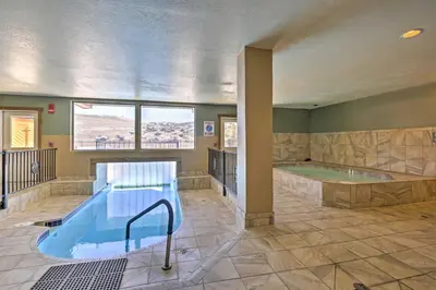 a large bathroom with a hot tub and a pool at Granby Condo with Pool Access, Near Hiking and Skiing! in Granby