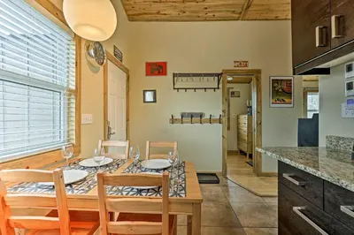 a kitchen and dining room with a table and chairs at 10 Mi to Ski Condo with Mtn Views in Silverthorne in Silverthorne