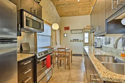 a large kitchen with a sink and a table at 10 Mi to Ski Condo with Mtn Views in Silverthorne in Silverthorne