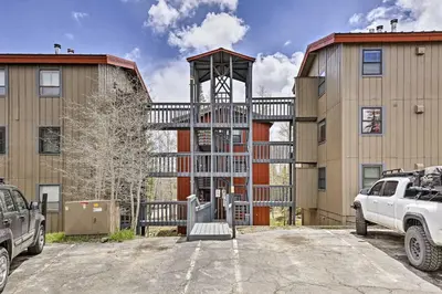 a building with a large balcony in a parking lot at 10 Mi to Ski Condo with Mtn Views in Silverthorne in Silverthorne