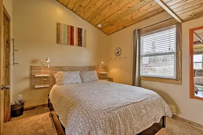 a bedroom with a bed and a large window at 10 Mi to Ski Condo with Mtn Views in Silverthorne in Silverthorne