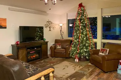 a living room with a christmas tree in a room at Estes Park Mountain-View Retreat 3 Miles to RMNP! in Estes Park