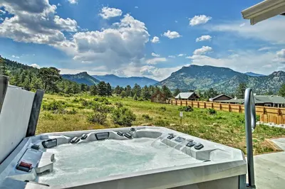 a hot tub with a view of a mountain at Estes Park Mountain-View Retreat 3 Miles to RMNP! in Estes Park