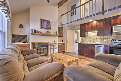 a large living room with couches and a kitchen at Fireplace and Stream Access Cozy Grand Lake Retreat in Grand Lake