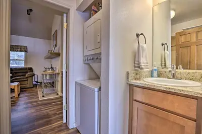 a bathroom with a sink and a washer at Fireplace and Stream Access Cozy Grand Lake Retreat in Grand Lake