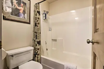 a bathroom with a white toilet and a shower at Fireplace and Stream Access Cozy Grand Lake Retreat in Grand Lake