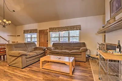 a living room with two couches and a coffee table at Fireplace and Stream Access Cozy Grand Lake Retreat in Grand Lake