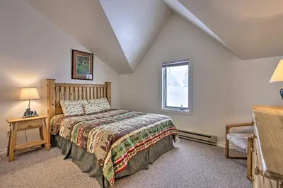 a bedroom with a bed and a window at Fireplace and Stream Access Cozy Grand Lake Retreat in Grand Lake