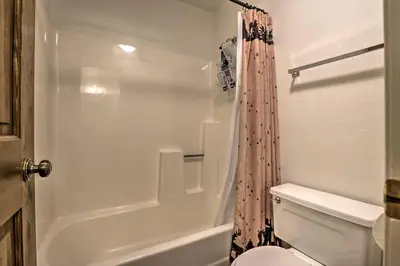 a bathroom with a white toilet and a shower at Fireplace and Stream Access Cozy Grand Lake Retreat in Grand Lake