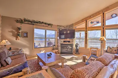 a living room with a couch and a table at Grand Lake House with Mountain Views, Deck! in Grand Lake