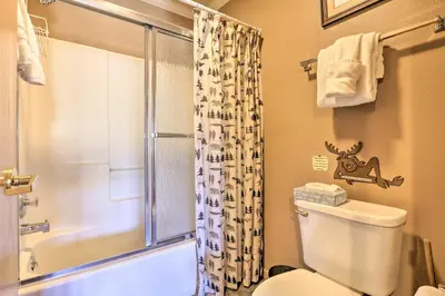 a bathroom with a toilet and a glass shower at Grand Lake House with Mountain Views, Deck! in Grand Lake