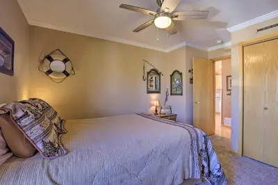 a bedroom with a bed and a ceiling fan at Grand Lake House with Mountain Views, Deck! in Grand Lake