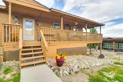 a home with a large deck and a yard at Grand Lake House with Mountain Views, Deck! in Grand Lake
