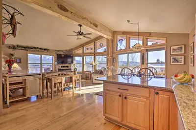 a kitchen with wooden cabinets and a table with bananas on it at Grand Lake House with Mountain Views, Deck! in Grand Lake
