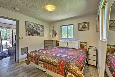 a bedroom with a bed and a window at Direct Beach Access Grand Lake Cabin with Deck! in Grand Lake