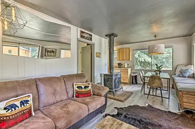 a living room with a couch and a table at Direct Beach Access Grand Lake Cabin with Deck! in Grand Lake