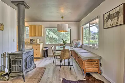 a kitchen with a stove and a dining room with a table at Direct Beach Access Grand Lake Cabin with Deck! in Grand Lake