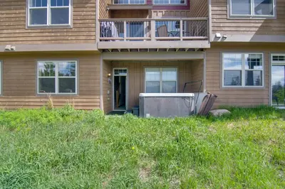 a house with an appliance in the grass in front of it at Winter Park Chalet with Hot Tub and Free Shuttle! in Fraser