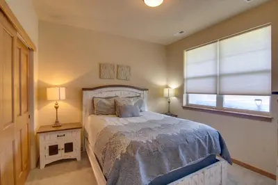 a bedroom with a bed and a window at Winter Park Chalet with Hot Tub and Free Shuttle! in Fraser