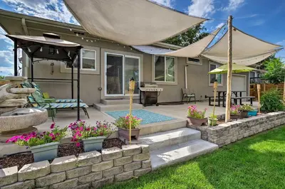 a backyard with a swimming pool and some flowers at 7 Mi to Dtwn Denver Arvada Home with Patio in Arvada