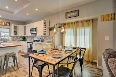 a kitchen and dining room with a table and chairs at 7 Mi to Dtwn Denver Arvada Home with Patio in Arvada