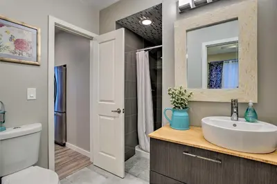 a bathroom with a sink and a mirror at 7 Mi to Dtwn Denver Arvada Home with Patio in Arvada