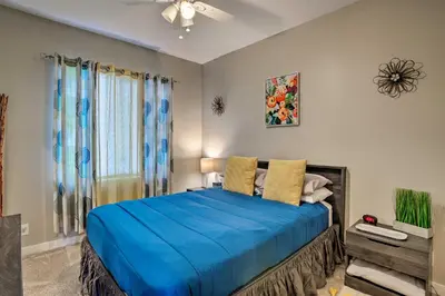a bedroom with a bed with a blue comforter at 7 Mi to Dtwn Denver Arvada Home with Patio in Arvada