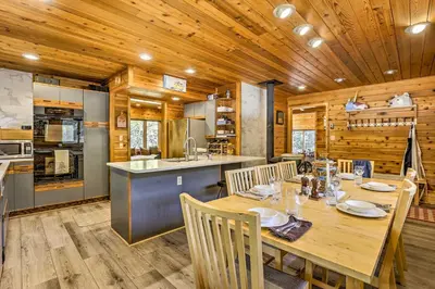 a kitchen and dining room with a table and chairs at Tranquil Dumont Home with Creek and Mtn Views! in Dumont