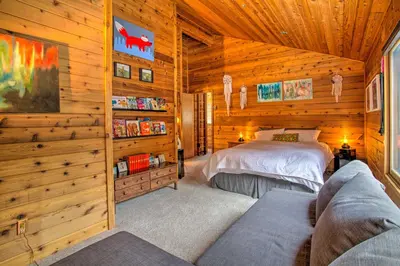 a bedroom with a bed in a log cabin at Tranquil Dumont Home with Creek and Mtn Views! in Dumont