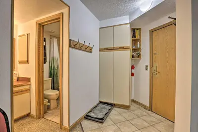 a bathroom with a toilet and a room with a door at Iron Horse Studio with Resort Amenities Walk to WP! in Winter Park
