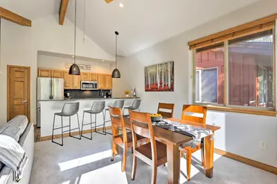a kitchen and dining room with a table and chairs at Riverfront Silverthorne Condo Near Skiing! in Silverthorne