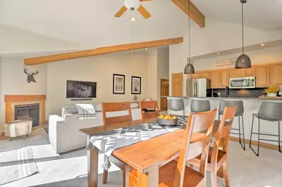 a kitchen and living room with a table and chairs at Riverfront Silverthorne Condo Near Skiing! in Silverthorne