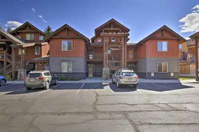 two cars parked in a parking lot in front of houses at Riverfront Silverthorne Condo Near Skiing! in Silverthorne