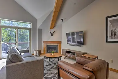 a living room with a couch and a tv at Riverfront Silverthorne Condo Near Skiing! in Silverthorne