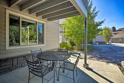 a patio with a table and chairs on a porch at 1 Block to Waterfront Grand Lake Condo with Balcony in Grand Lake