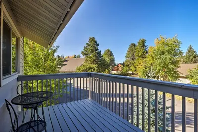 a balcony with a table and chairs on it at 1 Block to Waterfront Grand Lake Condo with Balcony in Grand Lake