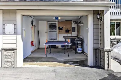 a garage with a ping pong table in it at 1 Block to Waterfront Grand Lake Condo with Balcony in Grand Lake
