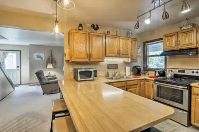 a kitchen with wooden cabinets and a wooden counter top at 1 Block to Waterfront Grand Lake Condo with Balcony in Grand Lake