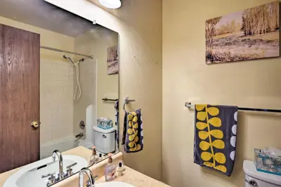 a bathroom with a sink and a mirror at 1 Block to Waterfront Grand Lake Condo with Balcony in Grand Lake
