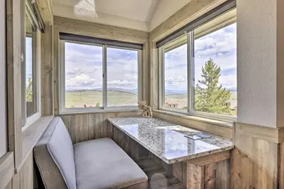 a room with windows and a table with a glass top at Updated Studio Loft in Granby Epic Mountain Views in Granby