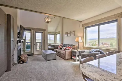 a living room with a couch and a tv at Updated Studio Loft in Granby Epic Mountain Views in Granby