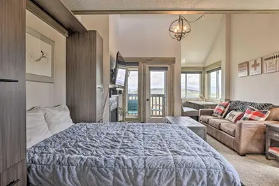 a bedroom with a bed and a couch at Updated Studio Loft in Granby Epic Mountain Views in Granby