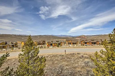 an empty road with houses in the distance at Updated Studio Loft in Granby Epic Mountain Views in Granby