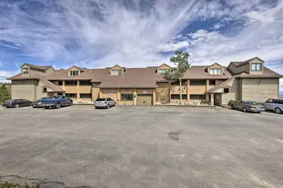 a large house with cars parked in a parking lot at Updated Studio Loft in Granby Epic Mountain Views in Granby