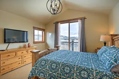 a bedroom with a bed and a tv and a window at 3 Mi to Granby Ranch Family-Friendly Home in Granby