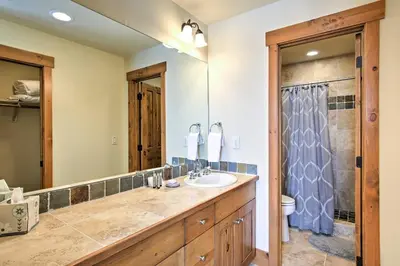 a bathroom with a sink and a large mirror at 3 Mi to Granby Ranch Family-Friendly Home in Granby