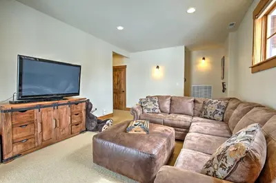 a living room with a couch and a flat screen tv at 3 Mi to Granby Ranch Family-Friendly Home in Granby