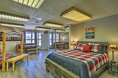 a bedroom with a bed and a loft at 2 Mi to Granby Ranch Condo with Hot Tub Access in Granby