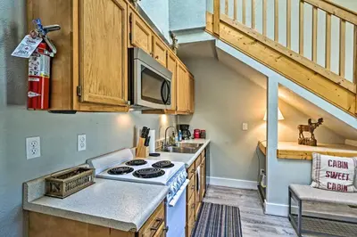 a small kitchen with a stove and a sink at 2 Mi to Granby Ranch Condo with Hot Tub Access in Granby