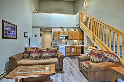 a living room with two couches and a kitchen at 2 Mi to Granby Ranch Condo with Hot Tub Access in Granby